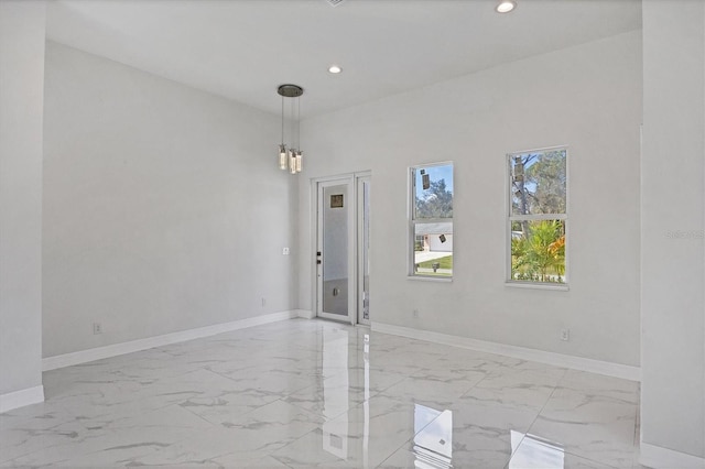 unfurnished room with a chandelier