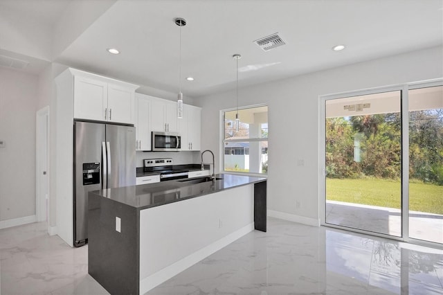 kitchen featuring stainless steel appliances, sink, a center island with sink, and white cabinets