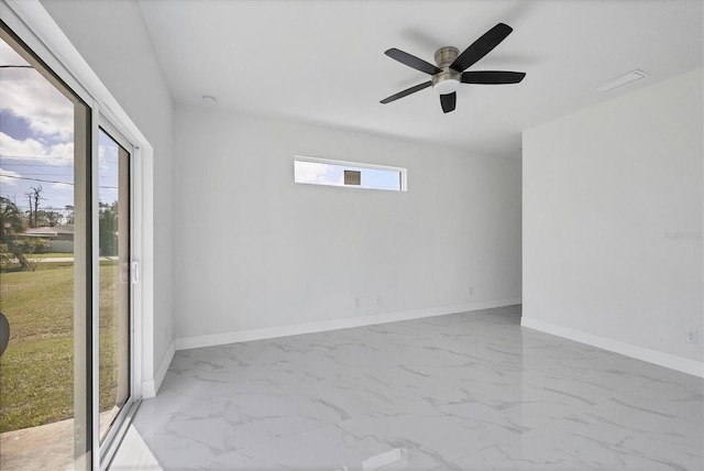 spare room with ceiling fan and plenty of natural light