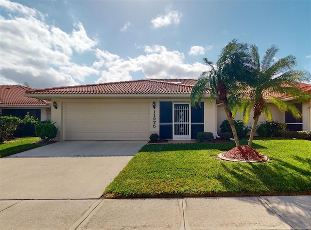 view of front of property with a front yard and a garage