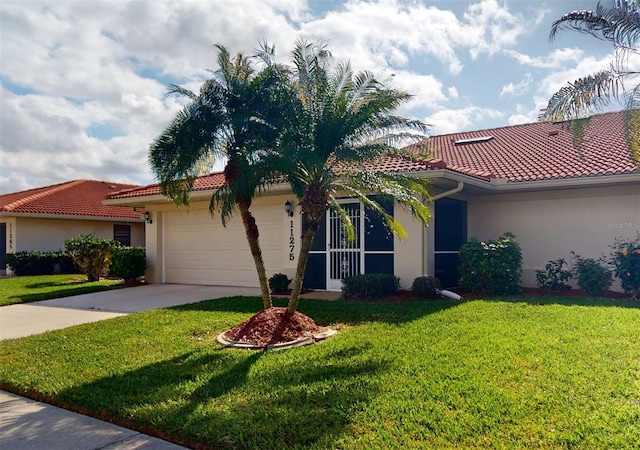 mediterranean / spanish-style home with a front lawn and a garage