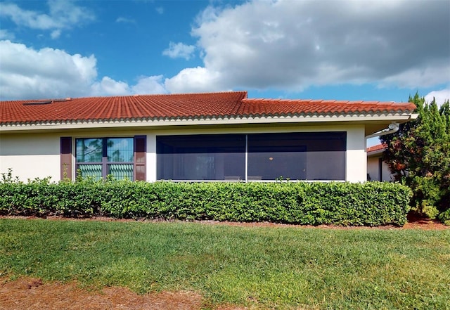 view of property exterior with a lawn