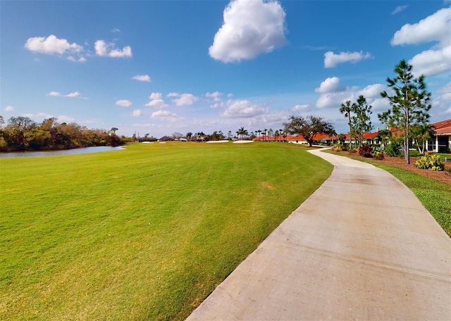 view of home's community featuring a yard and a water view