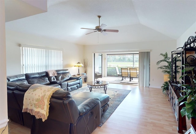 living room with light hardwood / wood-style flooring, lofted ceiling, and ceiling fan