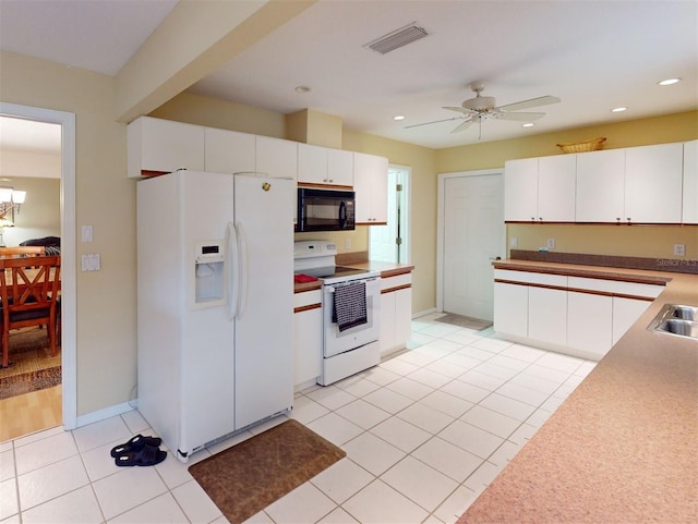 kitchen with electric range oven, white cabinets, ceiling fan, and white fridge with ice dispenser