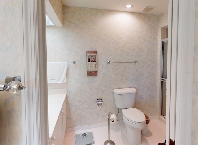 bathroom with vanity, toilet, tile patterned floors, and walk in shower