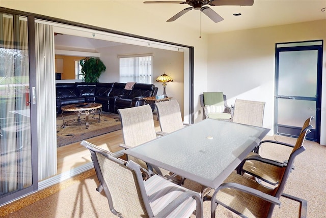 dining space with light wood-type flooring and ceiling fan