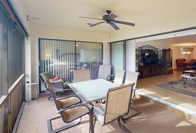 exterior space with ceiling fan with notable chandelier