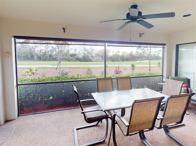 sunroom / solarium featuring a wealth of natural light and ceiling fan