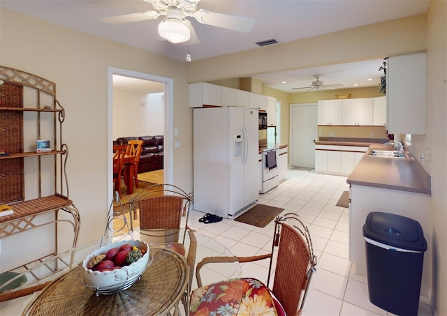 kitchen featuring white cabinetry, ceiling fan, white appliances, and light tile patterned floors