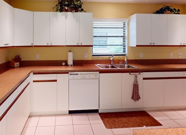 kitchen featuring sink, dishwasher, white cabinets, and light tile patterned floors