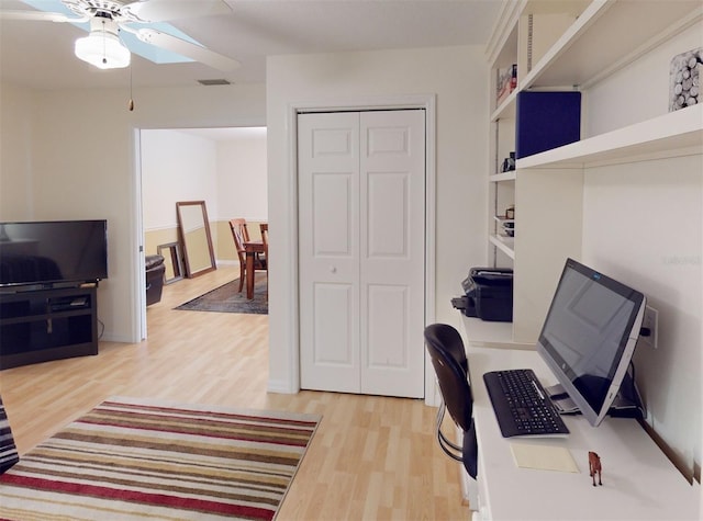 home office featuring wood-type flooring and ceiling fan