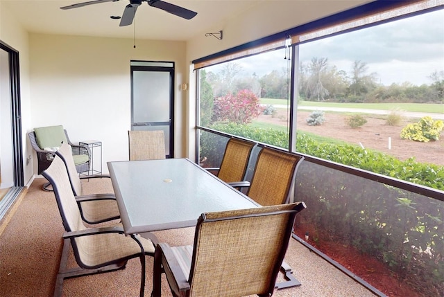 sunroom / solarium featuring ceiling fan