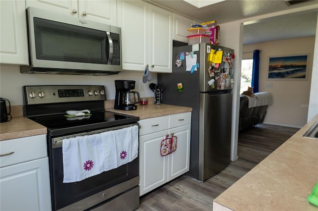 kitchen featuring white cabinetry, stainless steel appliances, and wood-type flooring