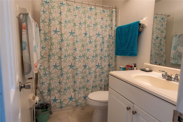 bathroom with walk in shower, vanity, toilet, and tile patterned flooring