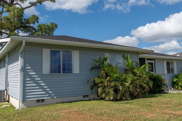 view of property exterior featuring central AC and a yard