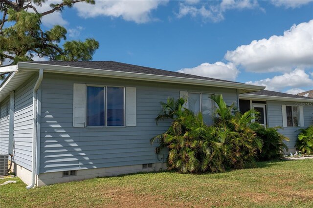 860 Columbia St, Port Charlotte, FL 33948 - view of home's exterior featuring crawl space, a yard, and central AC unit