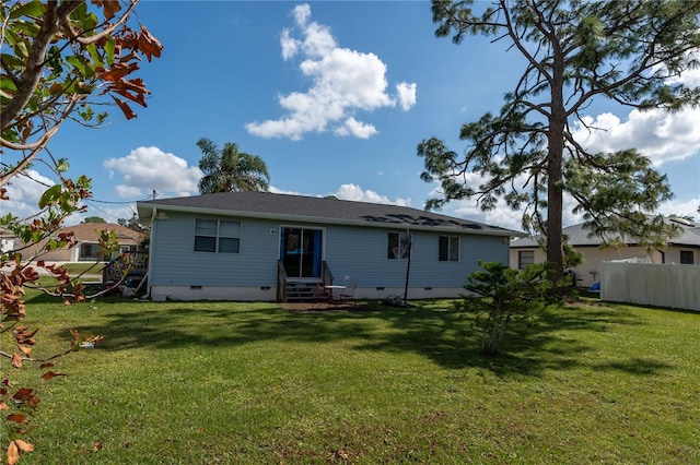 rear view of property with a lawn