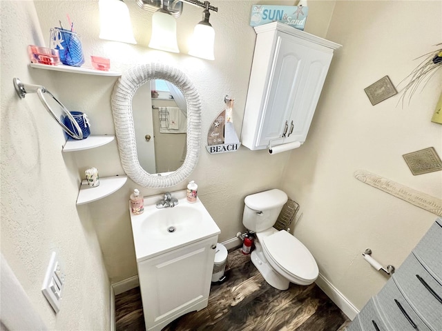 bathroom with vanity, hardwood / wood-style floors, and toilet