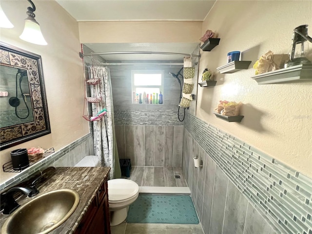 bathroom with vanity, curtained shower, toilet, and tile patterned flooring