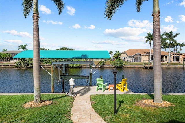 view of dock with a yard and a water view