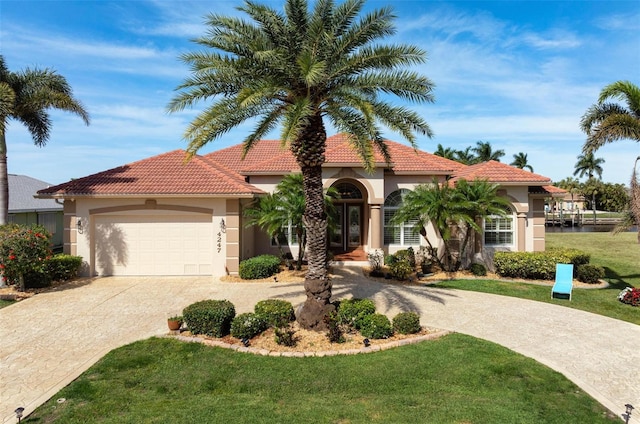 mediterranean / spanish-style house with a front lawn and a garage