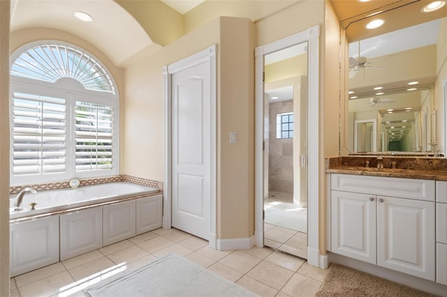 bathroom with vanity, ceiling fan, tile patterned flooring, and plus walk in shower