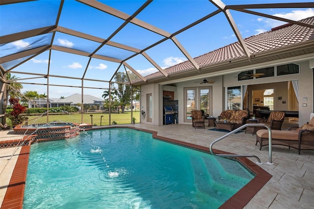 view of pool with area for grilling, ceiling fan, glass enclosure, and a patio area