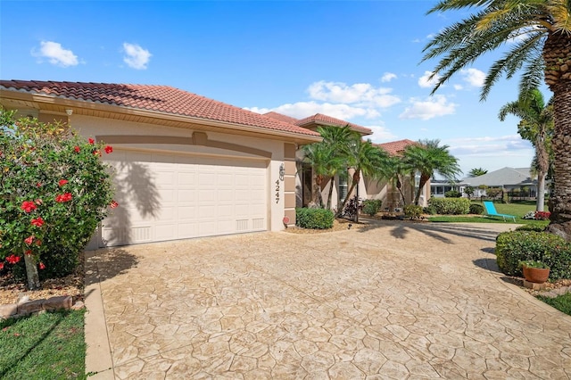 mediterranean / spanish-style house with a garage