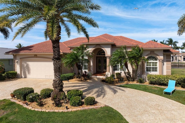 mediterranean / spanish house featuring a garage