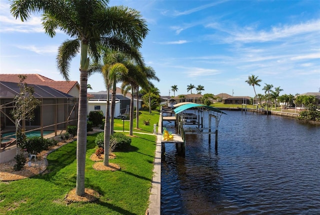 view of dock with a lawn, a water view, and glass enclosure