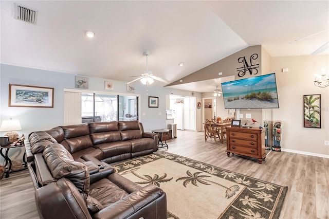 living room with ceiling fan, lofted ceiling, and light wood-type flooring