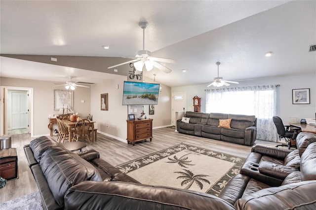 living room featuring vaulted ceiling and light wood-type flooring