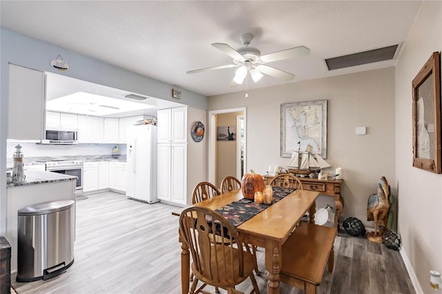 dining room with light hardwood / wood-style floors and ceiling fan