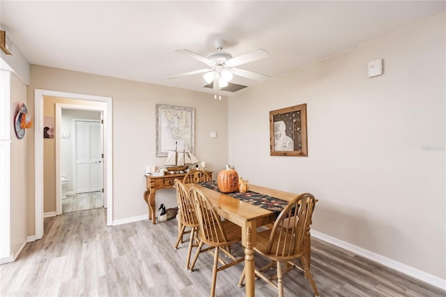 dining area with light hardwood / wood-style floors and ceiling fan