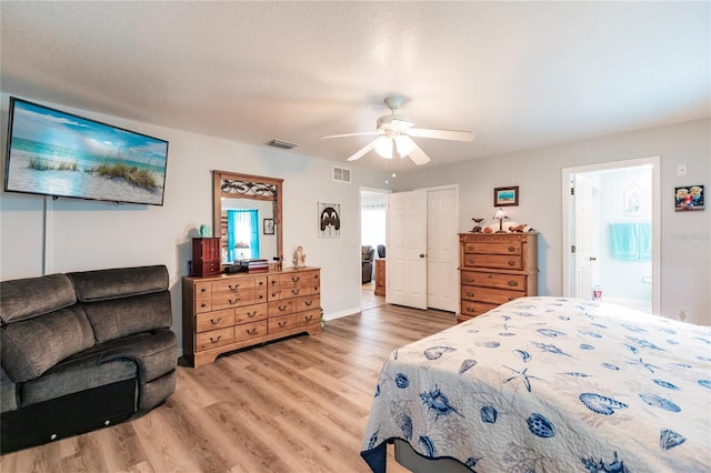 bedroom featuring hardwood / wood-style floors, ensuite bathroom, a textured ceiling, and ceiling fan