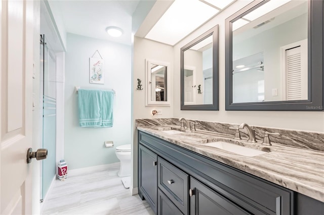 bathroom with toilet and vanity