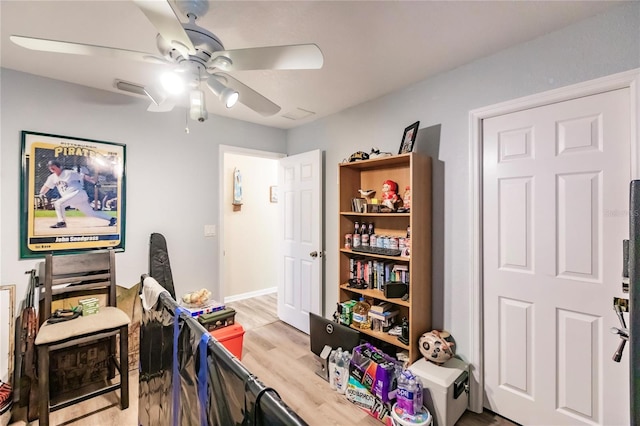 office featuring light hardwood / wood-style floors and ceiling fan