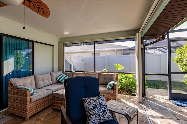 sunroom featuring ceiling fan