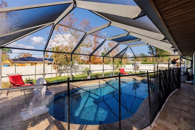 view of swimming pool with a patio area and glass enclosure