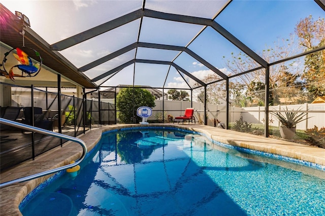 view of pool with glass enclosure