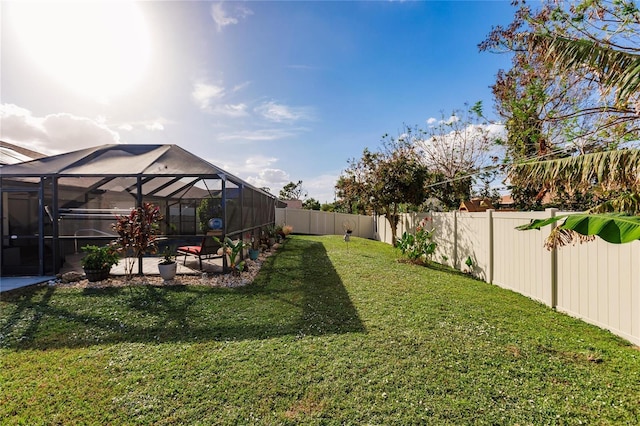 view of yard with glass enclosure