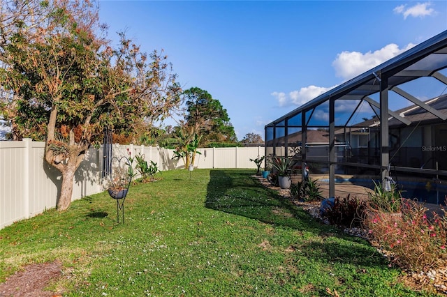 view of yard with a swimming pool and glass enclosure