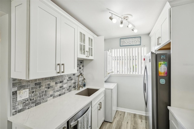 kitchen featuring white cabinets, stainless steel appliances, sink, and light wood-type flooring