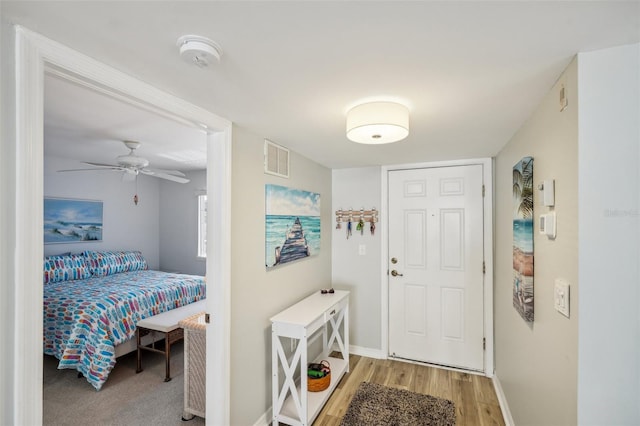 foyer featuring ceiling fan and hardwood / wood-style flooring