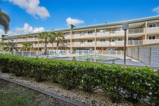 view of building exterior with a community pool