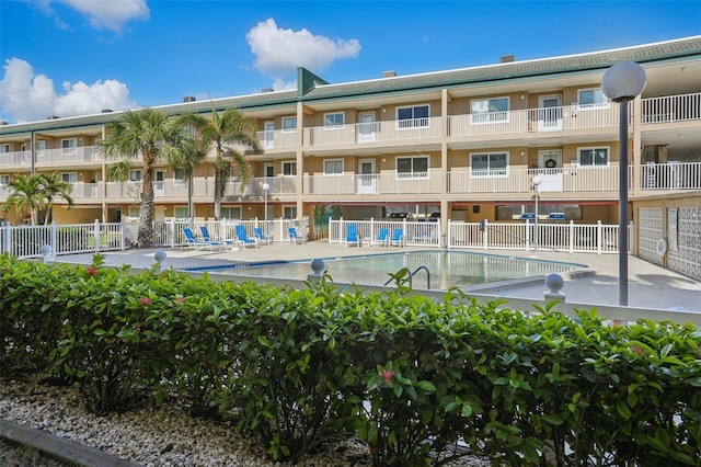 view of building exterior featuring a community pool