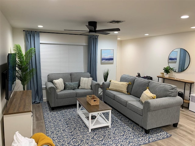 living room featuring ceiling fan and hardwood / wood-style floors