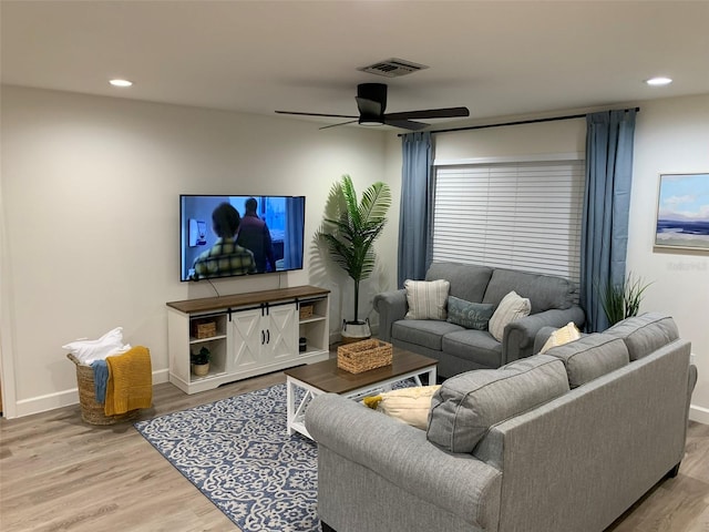 living room with ceiling fan and hardwood / wood-style flooring