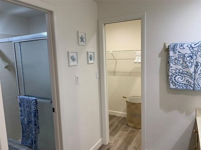 bathroom featuring vanity, hardwood / wood-style floors, and walk in shower